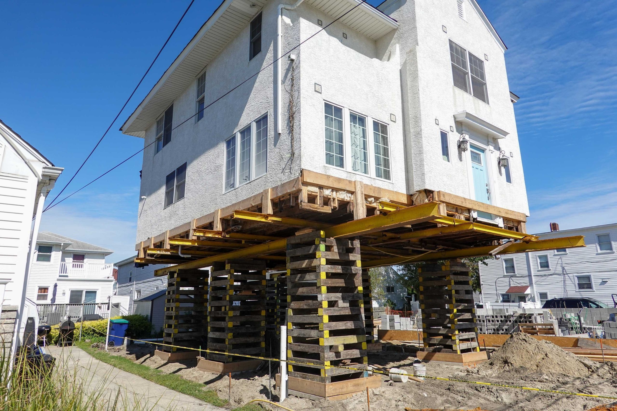 A team of professionals using specialized equipment to raise a house in Clearwater, preparing it for elevation and renovation